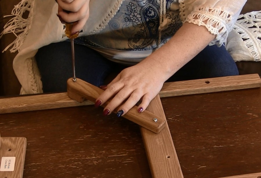 Woman assembling her floorstand using a screw driver