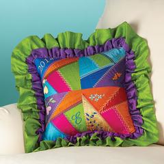 brighly colored crazy quilt patch pillow with purple and green ruffles