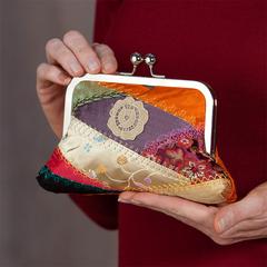 snapped clutch purse made of crazy quilted fabric with lace floral embellishment
