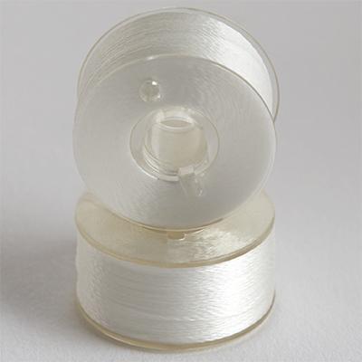 Two views  of Steady Stitch Style A Class 15 Plastic Sided Poly Spun bobbins