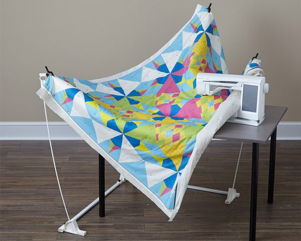 Weightless Quilter shown with machine, table,and quilt