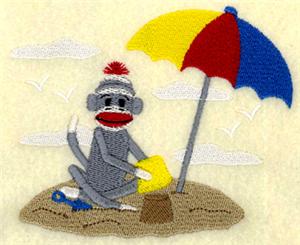 Sock Monkey Playing on Beach
