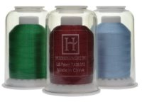 green red and blue spools of Hemingworth thread with caps and stoppers.