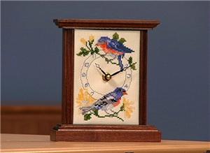 Embroidered mantel clock with birds.